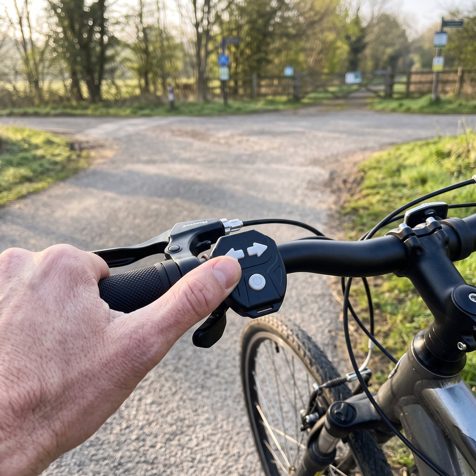 Thumb operating the handlebar remote